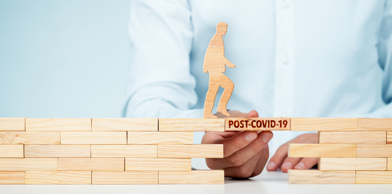 Image of person stacking blocks and connecting with block that says post-covid